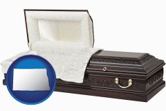 north-dakota map icon and an open funeral casket