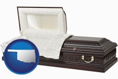 oklahoma map icon and an open funeral casket