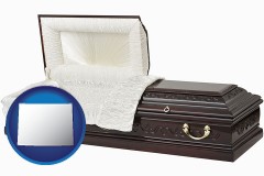 wyoming map icon and an open funeral casket