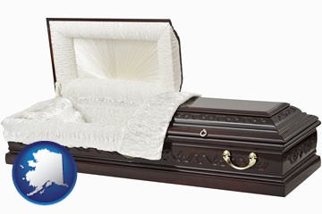 an open funeral casket - with Alaska icon