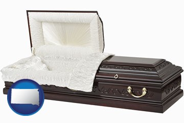 an open funeral casket - with South Dakota icon
