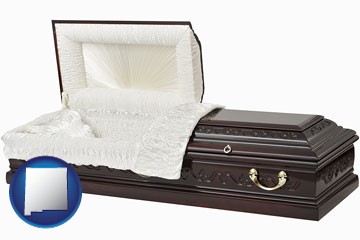 an open funeral casket - with New Mexico icon